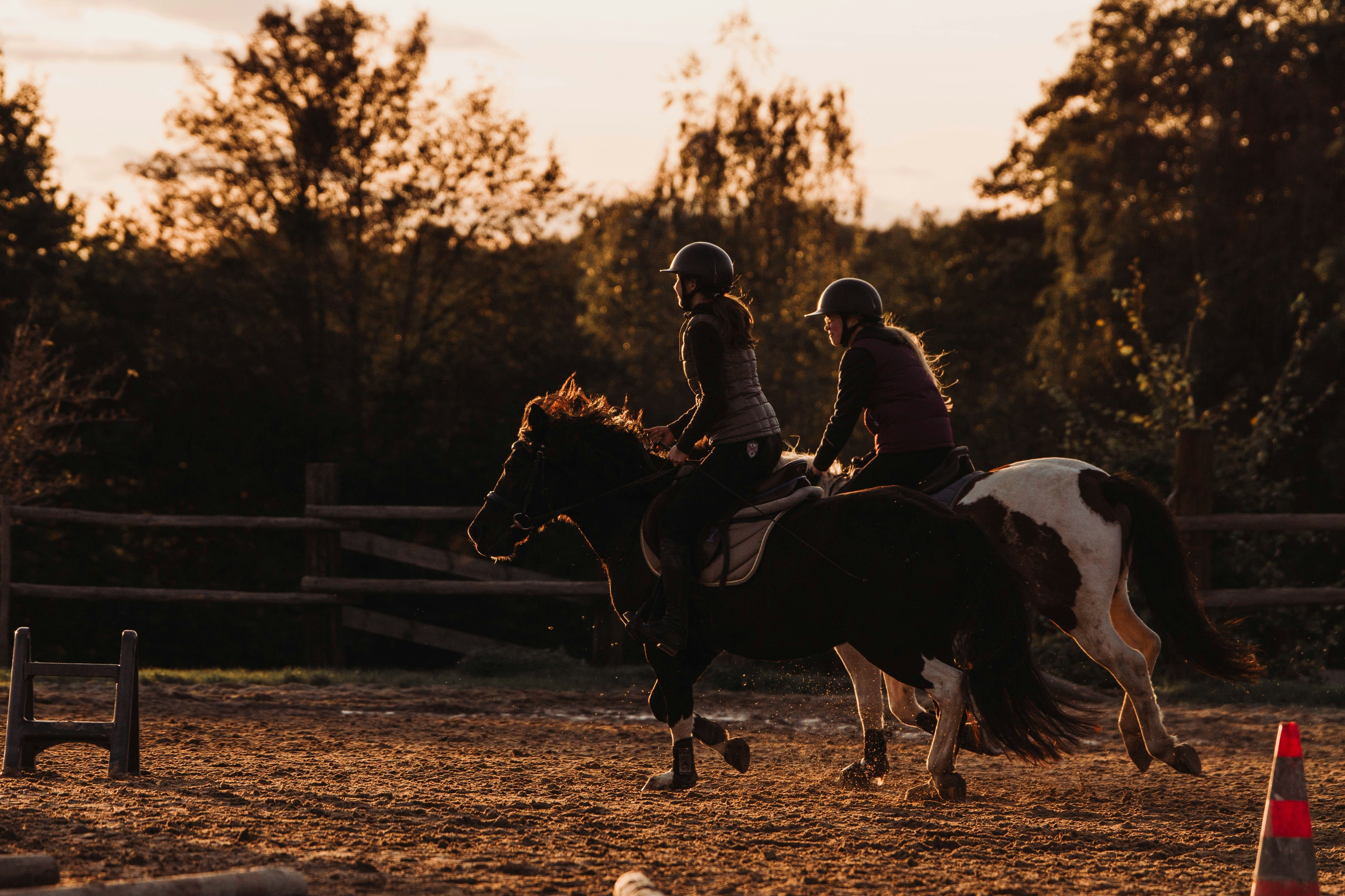 A person riding a horse through a field.